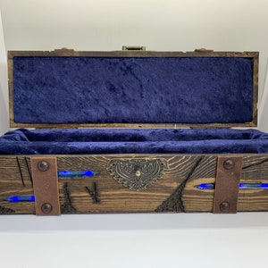May include: A wooden box with a blue velvet interior and metal accents. The box has a distressed finish and features blue resin accents.