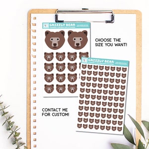 May include: Two sheets of stickers featuring brown grizzly bear faces. The smaller sheet has two large bear faces and eight smaller bear faces. The larger sheet has 49 smaller bear faces. The text on the sheets reads "Grizzly Bear Planner & Decoration Stickers" and "Choose the size you want!"