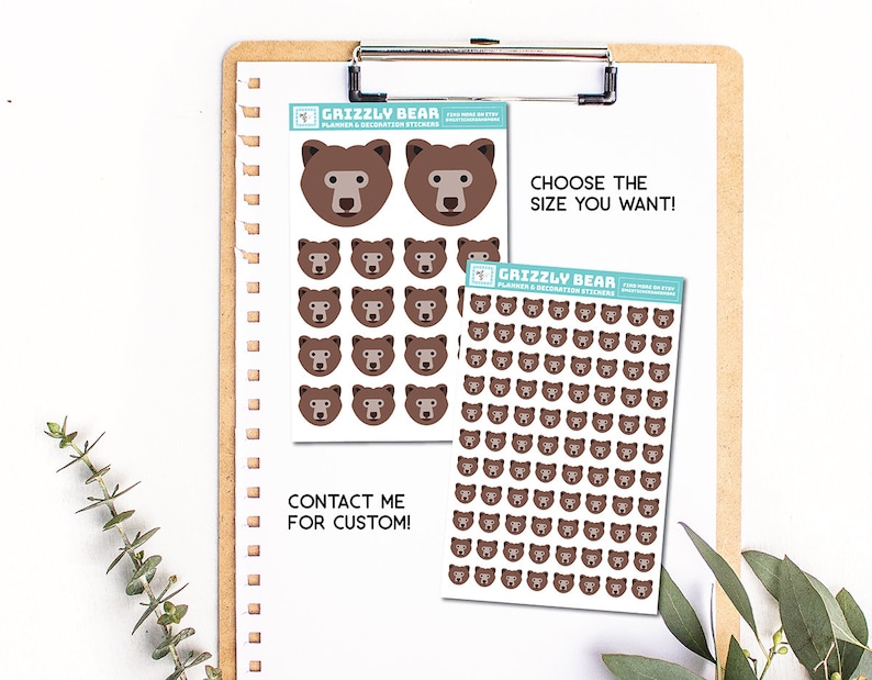 May include: Two sheets of stickers featuring brown grizzly bear faces. The smaller sheet has two large bear faces and eight smaller bear faces. The larger sheet has 49 smaller bear faces. The text on the sheets reads "Grizzly Bear Planner & Decoration Stickers" and "Choose the size you want!"