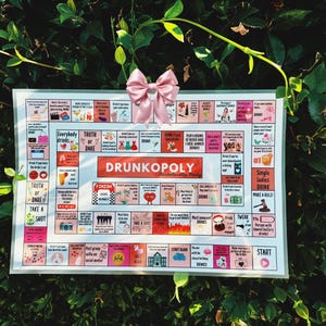 May include: A white game board with the title "Drunkopoly:  Parcheesi-style Party" printed in red and black. The board features squares with various prompts for drinking games, such as "Truth or Dare", "Take a Shot", and "Everybody Drinks".