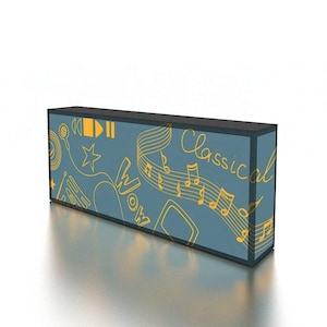 May include: A rectangular display box with a teal background and a black top. The box features yellow musical notes, headphones, and the word "Classical" in script. The word "Wow" is also visible.