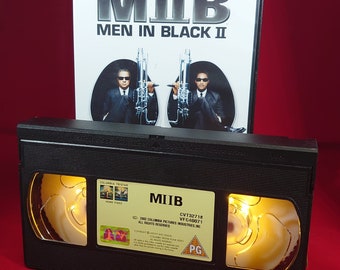 VHS nightlight of Men in Black 2 in warm yellow