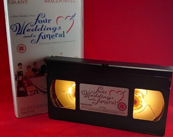 VHS nightlight of Four Wedding and a Funeral in warm yellow