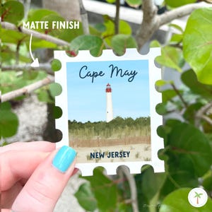 A Sticker Shaped Like A stamp that features the Cape May Lighthouse  located in New Jersey