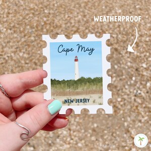 A Sticker Shaped Like A stamp that features the Cape May Lighthouse  located in New Jersey