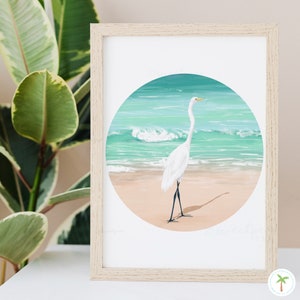 An Art Print of a gouache painting of a Great Egret on the beach right near the shoreline