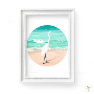 An Art Print of a gouache painting of a Great Egret on the beach right near the shoreline