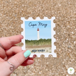 A Sticker Shaped Like A stamp that features the Cape May Lighthouse  located in New Jersey