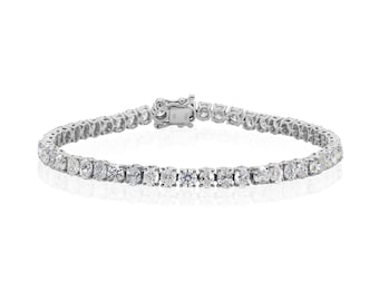 May include: A silver tennis bracelet with multiple round-cut, clear gemstones. The bracelet is clasped and lies on a white background. The gemstones are evenly spaced and reflect light.