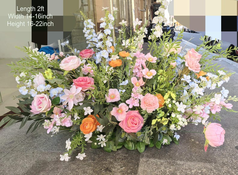 Puede incluir: Un gran arreglo floral con flores rosas, blancas y naranjas. El arreglo mide aproximadamente 60 cm de largo, 35-40 cm de ancho y 40-55 cm de alto.
