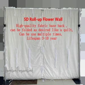 May include: White fabric backdrop with the text "5D Roll-up Flower Wall" and "High-quality fabric base back, can be folded as desired like a quilt, Can be use multiple times, Lifespan 3-10 year" in red text. The backdrop is attached to a metal frame.