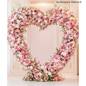 May include: A large heart-shaped floral arrangement made of pink and white flowers, with greenery accents. The structure is approximately 8 feet wide and 8 feet high, perfect for weddings or events. Text on the image reads "ArchFlowers W8xH8 ft".