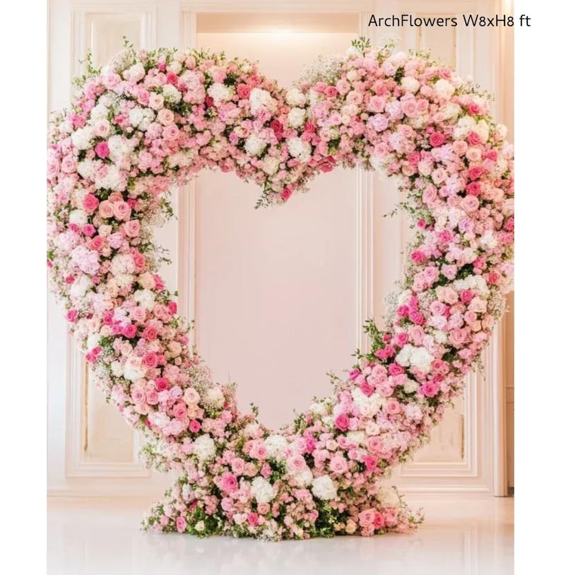 May include: A large heart-shaped floral arrangement made of pink and white flowers, with greenery accents. The structure is approximately 8 feet wide and 8 feet high, perfect for weddings or events. Text on the image reads "ArchFlowers W8xH8 ft".