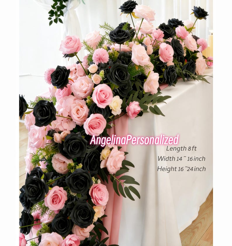 May include: A floral table runner featuring black and pink roses, with greenery accents. The arrangement is approximately 8 feet long, 14 to 16 inches wide, and 16 to 24 inches high. The text "AngelinaPersonalized" is visible.