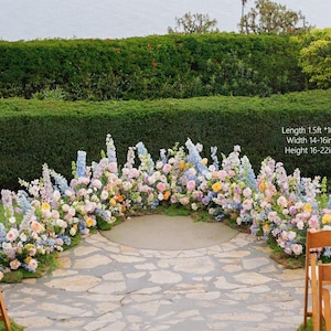 May include: A floral archway with a variety of pastel-colored flowers, including pink, blue, and yellow blooms. The arch is set on a stone pathway, with a green hedge in the background. The text on the image says: Length 1.5ft *10pcs, Width 14-16inch, Height 16-22inch.