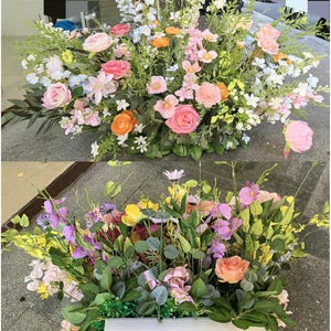May include: Two floral arrangements with a variety of flowers in shades of pink, orange, yellow, and purple. The arrangements are in rectangular containers. The word "Back" is visible in red on the bottom arrangement.