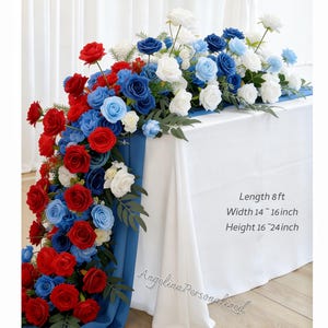 May include: A floral table runner featuring red, white, and blue roses and other flowers. The arrangement is on a white tablecloth with a blue runner. The text on the image says: Length 8 ft, Width 14 ~ 16 inch, Height 16 ~ 24 inch.