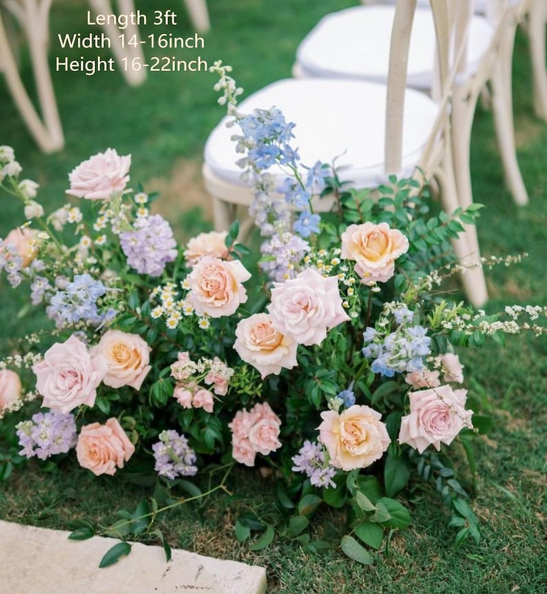 May include: A floral arrangement featuring light pink and peach roses, light blue delphiniums, and small white flowers with green foliage. Text on the image indicates a length of 3ft, a width of 14-16 inches, and a height of 16-22 inches.