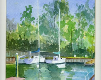May include: Watercolor painting of two sailboats docked in a calm harbor. The boats are white with blue sails, reflected in the green and blue water. Lush green trees line the background under a light blue sky. A small dock is visible on the left.
