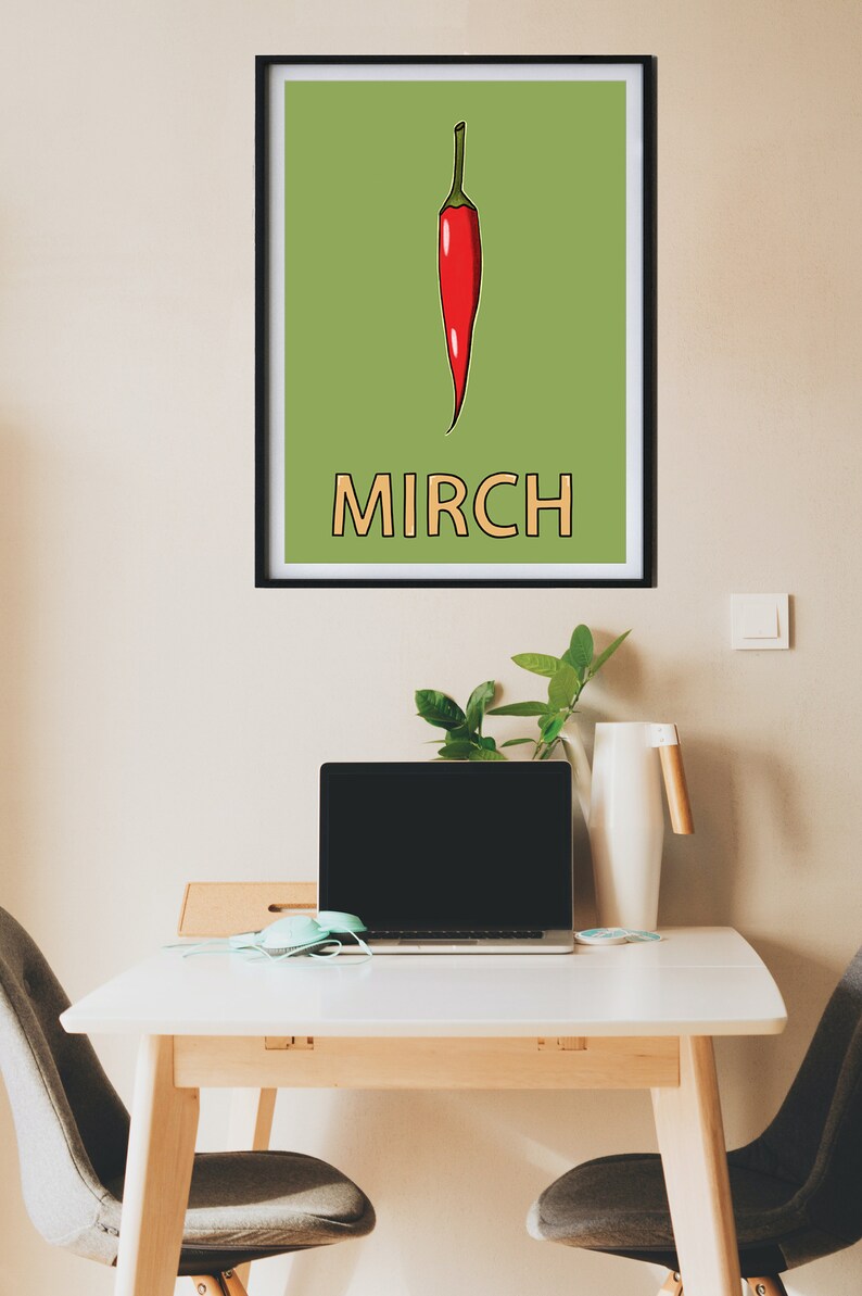May include: A framed print with a green background and a red chili pepper illustration. The word "MIRCH" is written in orange below the pepper.