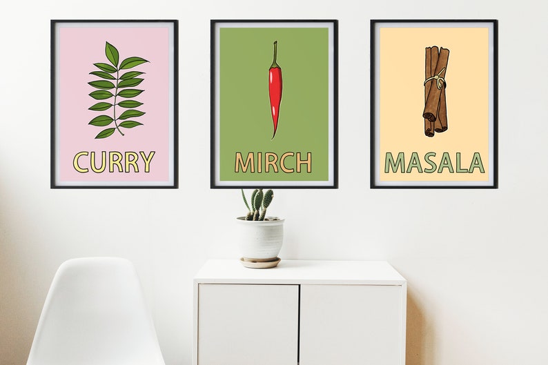 May include: Three framed prints with illustrations of curry leaves, a red chili pepper, and cinnamon sticks. The prints have a pink, green, and yellow background, respectively. The words "Curry", "Mirch", and "Masala" are written in yellow letters on each print.
