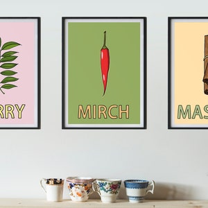 May include: Three framed prints with illustrations of spices. The first print has a green curry leaf on a pink background with the word "CURRY" in yellow letters. The second print has a red chili pepper on a green background with the word "MIRCH" in yellow letters. The third print has a bundle of cinnamon sticks on a yellow background with the word "MASALA" in green letters.