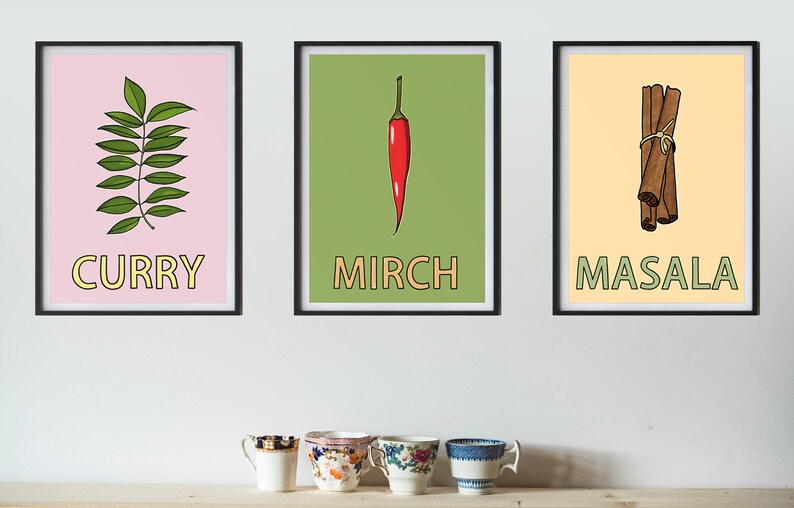 May include: Three framed prints with illustrations of spices. The first print has a green curry leaf on a pink background with the word "CURRY" in yellow letters. The second print has a red chili pepper on a green background with the word "MIRCH" in yellow letters. The third print has a bundle of cinnamon sticks on a yellow background with the word "MASALA" in green letters.