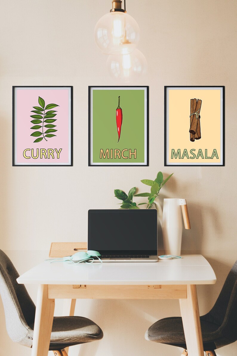 May include: Three framed prints with illustrations of spices and their names in English and Hindi. The prints are hung on a light beige wall. The prints are labeled "Curry", "Mirch", and "Masala".