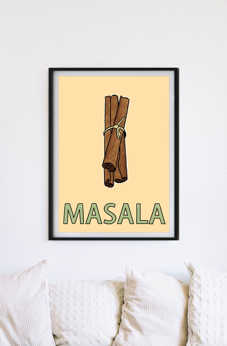 May include: A framed print with a yellow background featuring a cartoon illustration of a bundle of cinnamon sticks tied together with twine. The text "MASALA" is written in green letters below the cinnamon sticks.