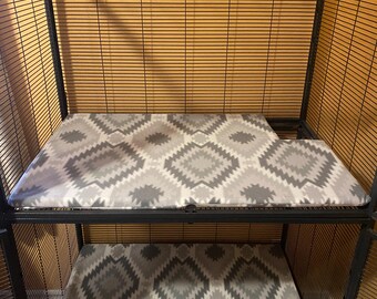 May include: A black metal cage with two tiers. Each tier has a grey and white patterned fleece liner.