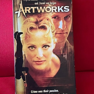 May include: A VHS video cassette cover for the movie "Artworks" starring Virginia Madsen, Rick Rossovich, and Eddie Mills. The cover features a close-up of Virginia Madsen and Rick Rossovich. The text on the cover reads "Crime was their passion. Betrayal their masterpiece."