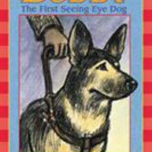 May include: A book cover featuring a cartoon illustration of a dog wearing a harness and being led by a hand. The title of the book is "Buddy The First Seeing Eye Dog".