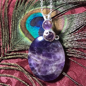 Amethyst crystal pendant w/2 beads and silver toned wire.A healing stone to dispel stress&anger. Meditation crystal. Good crystal therapy!