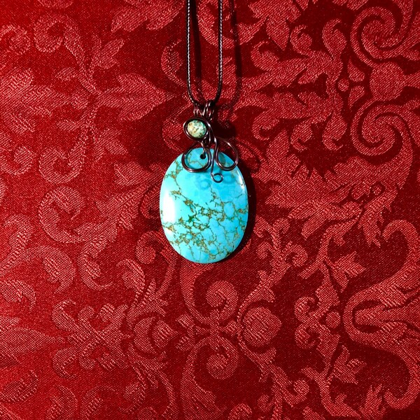 Turquoise howlite abstract pendant w/gunmetal tarnish resistant wire.African turquoise faceted bead.A beautiful cabochon& a fantastic piece