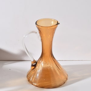 MCM Mid Century Hand Blown Glass Optic Pitcher in Amber, concave base, and clear applied handle