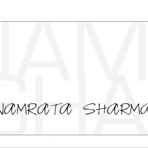 May include: A white business card with the text "NAMRATA SHARMA" in black cursive writing.