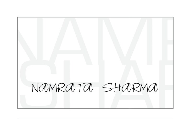 May include: A white business card with the text "NAMRATA SHARMA" in black cursive writing.