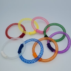 May include: Eight colorful, sparkly, woven, stretchy bracelets in various colors, including red, yellow, green, blue, purple, orange, white, and pink.