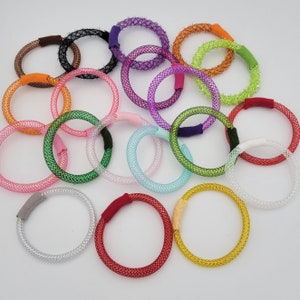 May include: A collection of colorful, sparkly hair ties in various sizes and colors. The hair ties are made of a soft, stretchy material and are perfect for holding back hair.