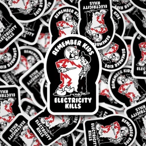 May include: A black and white sticker with a cartoon character holding a knife and the text "Remember Kids Electricity Kills".