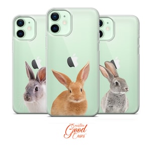 May include: Three clear phone cases with different images of rabbits. The cases are mint green and feature a rabbit with brown fur, a gray rabbit, and a gray and white rabbit.