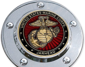 May include: A chrome-plated round emblem with a red, gold, and black United States Marine Corps logo. The logo features a globe, an eagle, and an anchor. The text "United States Marine Corps" and "Jarhead" are inscribed around the logo.