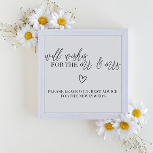 Może przedstawiać: Biały znak z czarnym tekstem, który brzmi "well wishes for the Mr & Mrs" z symbolem serca i "Please leave your best advice for the newlyweds". Znak jest otoczony białymi stokrotkami.