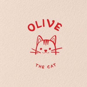 K&ouml;nnte beinhalten: Rote Illustration einer Katze mit dem Namen "Olive the Cat" dar&uuml;ber.