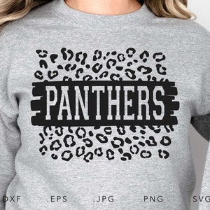 May include: A gray sweatshirt with a black and white leopard print design. The word "PANTHERS" is written in white letters on a black rectangle.
