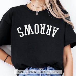 May include: Black t-shirt with the word "ARROWS" in white, arched lettering. The shirt is a crew neck style and appears to be made of a soft material. The shirt is worn by a person.