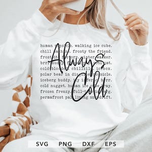 May include: White long-sleeve sweatshirt with the words "Always Cold" in a handwritten font. Surrounding the text are phrases like "human popsicle" and "frosty the friend". The bottom of the shirt has the file type abbreviations: SVG, PNG, DXF, and EPS.
