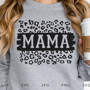 May include: A gray sweatshirt with a black leopard print design and the word "MAMA" in white letters on a black background.