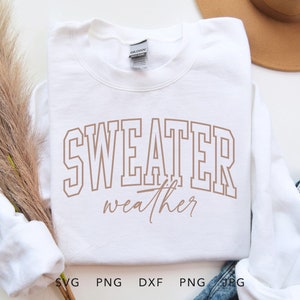 May include: White sweatshirt with the text "sweater weather" in brown lettering.
