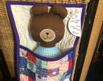 stuffed bear in sleeping bag